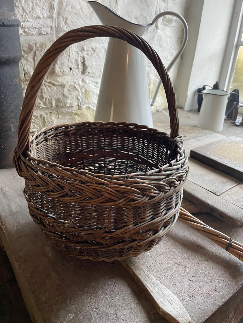 Round loop handle basket with decorative border at Acton Scott Heritage Farm